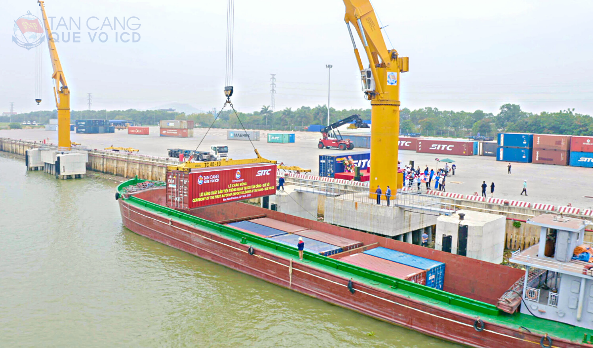 The first container cleared at TCQV is loaded onto the barge